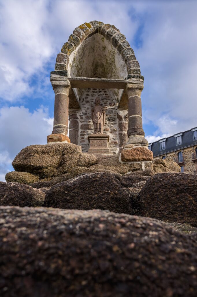 Explore the historic Saint-Guirec Oratory in Perros-Guirec, contrasting old stone with the blue sky.
