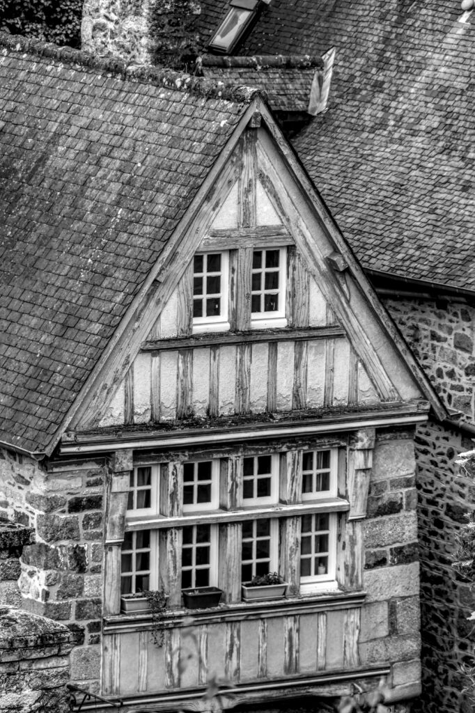 Rustic stone and timber house facade in Brittany, evoking historic charm.